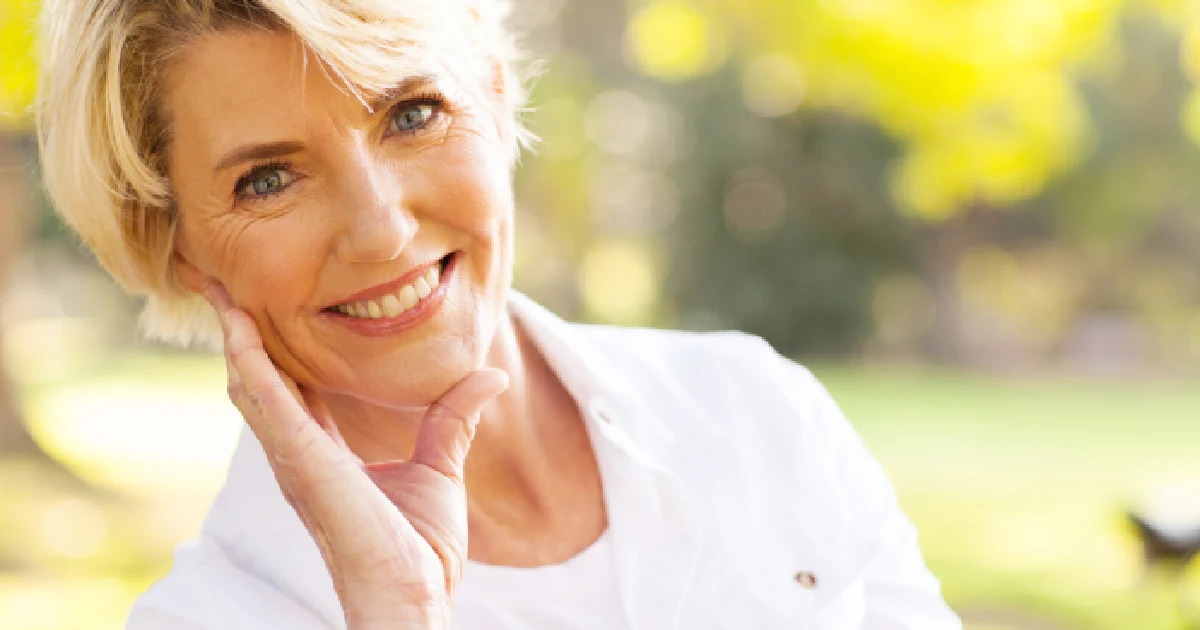Smiling middle-aged woman taking Hormone Replacement Therapy during menopause in Florence, KY